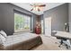 Stylish bedroom with a ceiling fan, window shutters, a built-in desk, and neutral decor at 16039 Ternglade Dr, Lithia, FL 33547