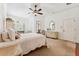 Cozy bedroom with soft carpet, white trim, plantation shutters, and direct bathroom access for convenience at 16039 Ternglade Dr, Lithia, FL 33547