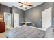 Cozy bedroom featuring a ceiling fan, comfortable bed, and a built-in desk at 16039 Ternglade Dr, Lithia, FL 33547