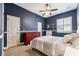 Comfortable bedroom featuring a ceiling fan, a large window with shutters, and stylish decor at 16039 Ternglade Dr, Lithia, FL 33547
