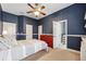Inviting bedroom with blue walls, a ceiling fan, and an ensuite bathroom at 16039 Ternglade Dr, Lithia, FL 33547