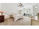 Serene bedroom with neutral colors, plush carpet, shutters, and an eclectic mix of vintage furnishings at 16039 Ternglade Dr, Lithia, FL 33547