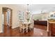 Bright dining area with hardwood floors, white table set, and easy access to the living room at 16039 Ternglade Dr, Lithia, FL 33547
