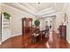 Bright dining room with wood floors, coffered ceilings, chandelier, and french doors leading to the patio at 16039 Ternglade Dr, Lithia, FL 33547