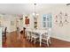 Dining room with wooden floors, white table and chairs, and plantation shutters at 16039 Ternglade Dr, Lithia, FL 33547