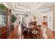 Elegant dining room boasts wood floors, detailed trim, a chandelier, and french doors leading to the backyard at 16039 Ternglade Dr, Lithia, FL 33547