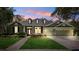 Charming one-story home featuring a three-car garage, well-manicured lawn, and attractive landscaping at 16039 Ternglade Dr, Lithia, FL 33547