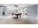 Spacious game room with a pool table, neutral walls, ceiling fan, and doorway to a bathroom at 16039 Ternglade Dr, Lithia, FL 33547