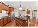 Kitchen island with granite countertop and stainless steel appliances at 16039 Ternglade Dr, Lithia, FL 33547