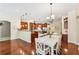 Open floor plan kitchen with a large island, stainless appliances, and adjacent dining area with white table set at 16039 Ternglade Dr, Lithia, FL 33547