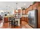 Cozy kitchen with dark wood cabinets, stainless appliances, a breakfast bar, and hardwood flooring at 16039 Ternglade Dr, Lithia, FL 33547