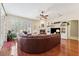 Spacious living room features a brick fireplace, hardwood floors, and abundant natural light from large windows at 16039 Ternglade Dr, Lithia, FL 33547