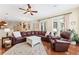 Open-concept living room with comfortable seating, a ceiling fan, and seamless flow into the dining area at 16039 Ternglade Dr, Lithia, FL 33547