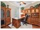 Elegant office featuring wood floors, built-in shelving, and natural light at 16039 Ternglade Dr, Lithia, FL 33547