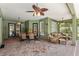 Enclosed patio featuring outdoor furniture, lighting, and brick flooring for comfortable outdoor living at 16039 Ternglade Dr, Lithia, FL 33547