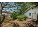 Backyard featuring lush landscaping, mature trees, and a view of the side of the house at 1648 Concord St, Dunedin, FL 34698