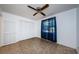 Bedroom with neutral tile flooring and a spacious closet, and a large window at 1648 Concord St, Dunedin, FL 34698