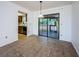 Dining area featuring neutral tile flooring and sliding glass doors to the outside patio at 1648 Concord St, Dunedin, FL 34698