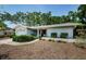 Beautiful one-story home featuring a manicured lawn and freshly painted white exterior at 1648 Concord St, Dunedin, FL 34698