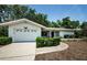 Inviting one-story home with a well-maintained lawn and an attached garage at 1648 Concord St, Dunedin, FL 34698