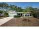 Charming single-story home with a well-manicured lawn and a neatly paved driveway at 1648 Concord St, Dunedin, FL 34698