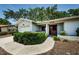 Cozy single-story home with an attached garage and a neatly trimmed front yard at 1648 Concord St, Dunedin, FL 34698