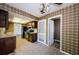 This kitchen boasts tile floors, dark cabinets, and modern appliances with easy access to a dining area at 1648 Concord St, Dunedin, FL 34698