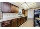 Kitchen showcasing wood cabinets, stainless steel sink and black dishwasher at 1648 Concord St, Dunedin, FL 34698