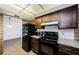 Bright kitchen featuring wood cabinets and black appliances at 1648 Concord St, Dunedin, FL 34698