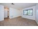 Bright living room with neutral tile flooring and a large window offering natural light at 1648 Concord St, Dunedin, FL 34698