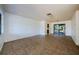 Spacious living room with tile flooring and a sliding glass door to the outside at 1648 Concord St, Dunedin, FL 34698