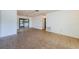 Open-concept living room featuring neutral tile flooring and access to the backyard at 1648 Concord St, Dunedin, FL 34698