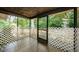 Enclosed patio featuring tile flooring and decorative lattice screening offering serene outdoor living at 1648 Concord St, Dunedin, FL 34698