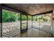 Enclosed porch featuring tile floors and a view to the outdoor space at 1648 Concord St, Dunedin, FL 34698