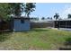 A well-maintained backyard features a storage shed, a fire pit, and enough space for gardening and other activities at 1665 Grove St, Clearwater, FL 33755