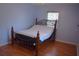 Bedroom features natural light from window, hardwood floors, ceiling fan and a double bed at 1665 Grove St, Clearwater, FL 33755
