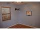 Comfortable bedroom featuring a mounted TV and a window with wooden blinds, perfect for relaxation and entertainment at 1665 Grove St, Clearwater, FL 33755