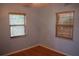 Cozy bedroom featuring two windows with wood blinds, providing natural light and privacy at 1665 Grove St, Clearwater, FL 33755