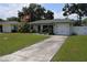 Charming single-story home featuring a well-maintained lawn and an attached garage at 1665 Grove St, Clearwater, FL 33755