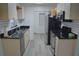 The kitchen offers stainless steel appliances, light cabinets with black countertop, and subway tile backsplash at 1665 Grove St, Clearwater, FL 33755