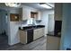 Bright kitchen features light cabinets, black countertops, subway tile backsplash, and stainless steel appliances at 1665 Grove St, Clearwater, FL 33755