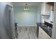 Kitchen view with stainless steel appliances and light cabinetry, opens to dining area at 1665 Grove St, Clearwater, FL 33755