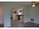 View of the bright kitchen with stainless steel appliances, new gray floors, and ample natural light at 1665 Grove St, Clearwater, FL 33755