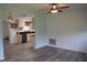 Bright living room with neutral paint and gray floors leading into the kitchen at 1665 Grove St, Clearwater, FL 33755