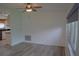 Light-filled living area transitioning into the kitchen, featuring updated floors and fixtures at 1665 Grove St, Clearwater, FL 33755