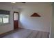 Bright living room with new floors, front door, and accent shelf at 1665 Grove St, Clearwater, FL 33755