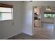 Open living space offers views to kitchen, bright windows, and hardwood flooring at 1665 Grove St, Clearwater, FL 33755