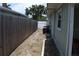 This property has a side yard with an HVAC unit, bordered by a wooden fence and the house, offering privacy at 1665 Grove St, Clearwater, FL 33755