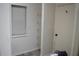 A walk-in closet with built-in shelving provides organized storage space with a window for natural light and vinyl floors at 1665 Grove St, Clearwater, FL 33755