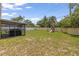 Expansive backyard with a playset and shaded patio area, perfect for outdoor activities and entertaining at 1720 Fruitridge St, Brandon, FL 33510